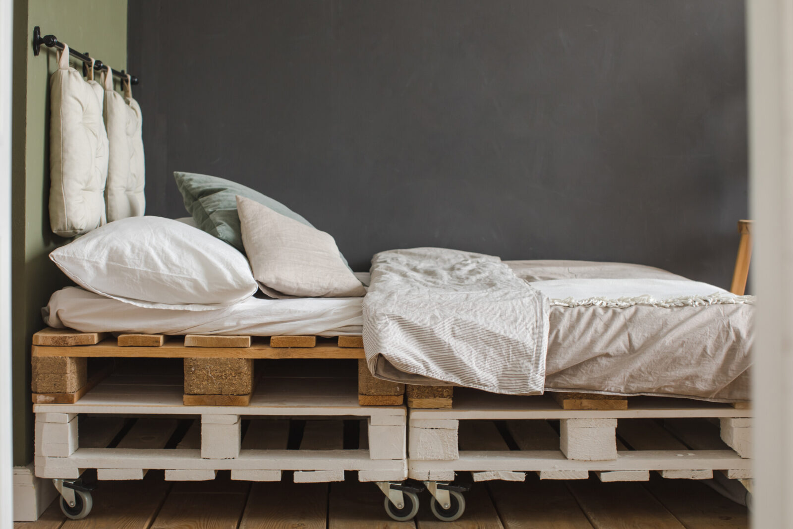 industrial style bedroom with recycled pallet bed